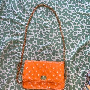 It’s a orange clutch/purse. You could use it on your shoulder.